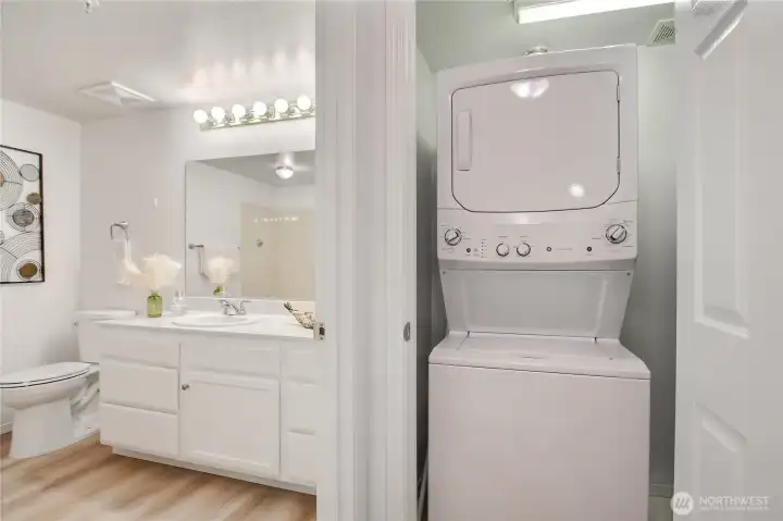 Utility closet with space saving stacking washer and dryer.