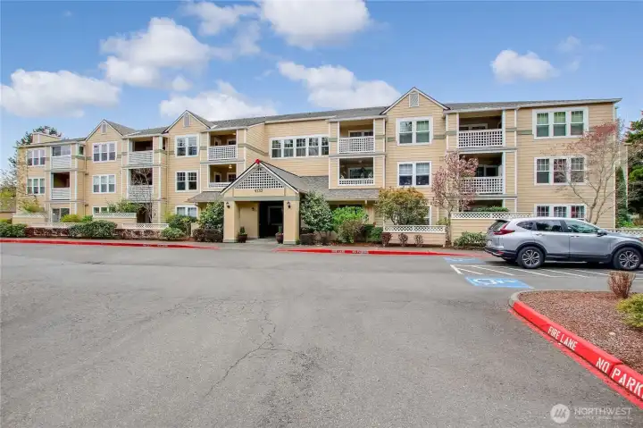Exterior View of the Pacific Building #112 in Washington Village. Condo has garage space #15 in open garage with Garage door.