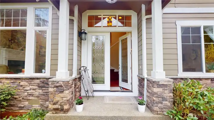 The entry features beautiful french stained glass doors