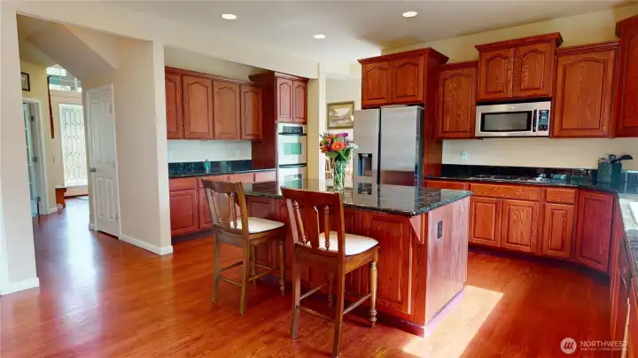 The expansive kitchen is a chef's delight with custom granite countertops