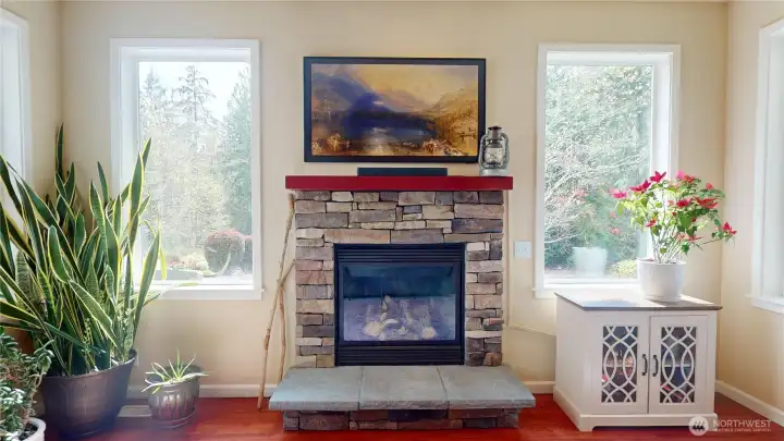 An additional gas fireplace with stack stone surround can be found in the family room