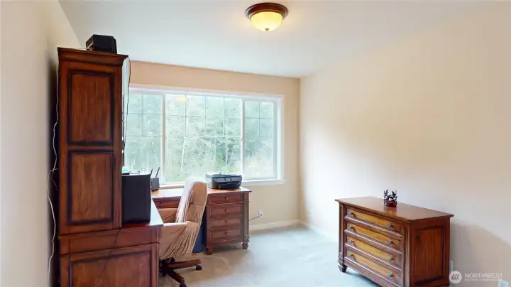 The first of three bedrooms, this one overlooking the front of the home