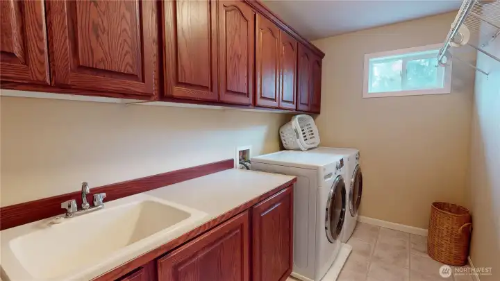 The laundry room with utility sink is conveniently located upstairs