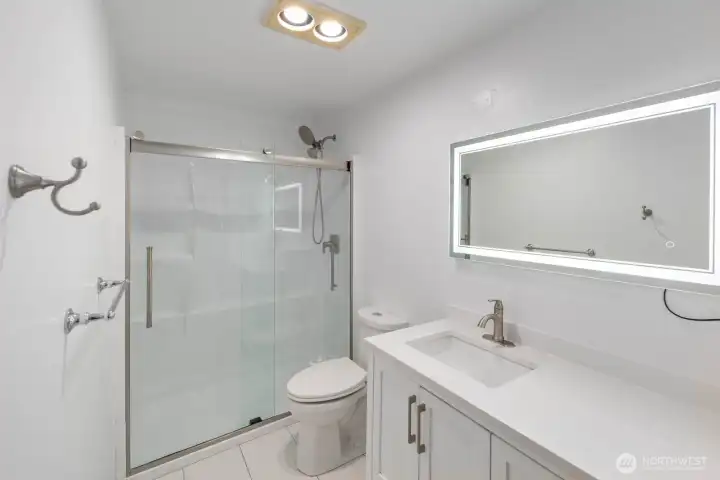 Bathroom features a lighted mirror!