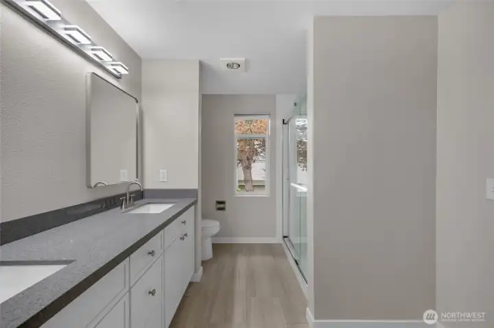 Private ensuite bath with dual sink vanity.