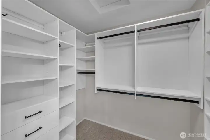 Walk-in closet with California Closets custom shelving.