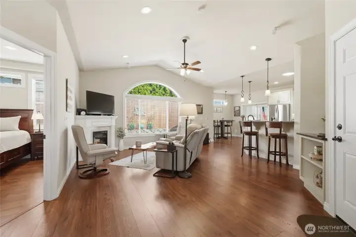 Open-concept great room featuring vaulted ceilings, large windows, and abundant natural light.