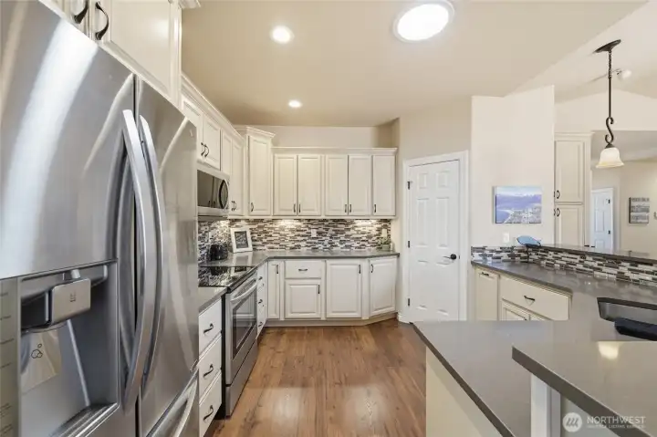 Chef-inspired kitchen featuring stainless steel appliances, custom cabinetry, and abundant counter space.