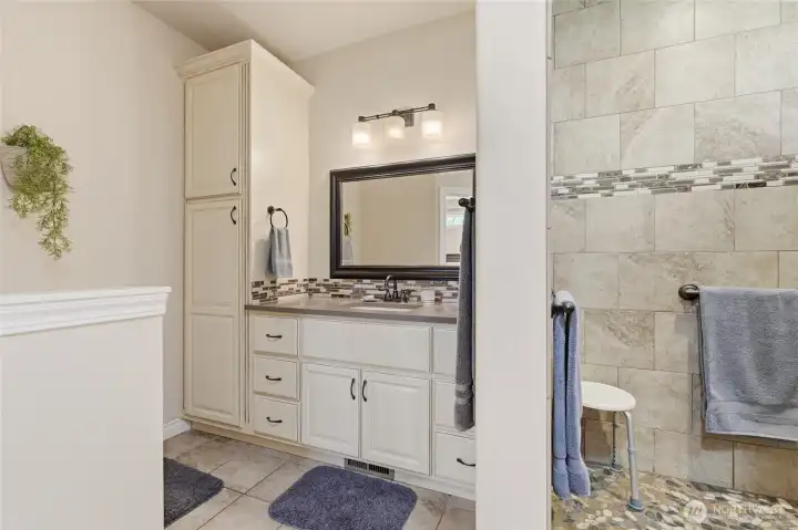 Luxury primary bathroom featuring dual vanities and extensive countertop space.