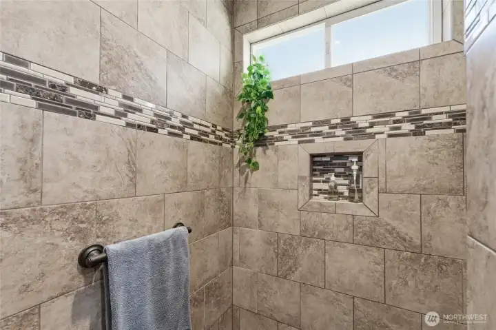 Spa-inspired walk-in tile shower with beautiful custom tile finishes.