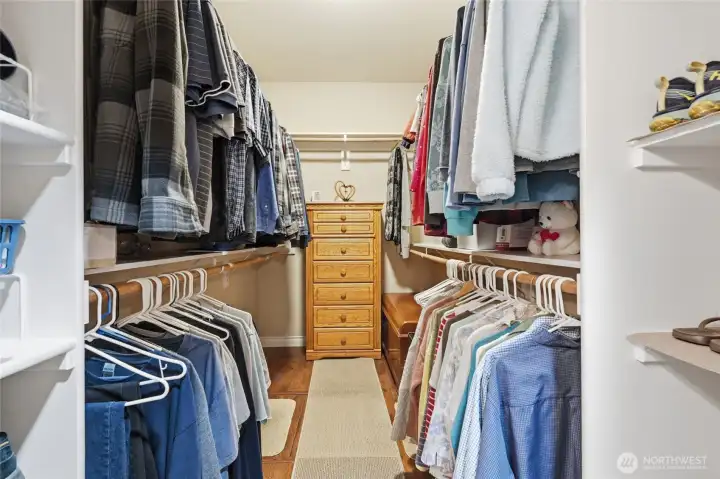 Generous walk-in closet with extensive hanging space and built-in organization.