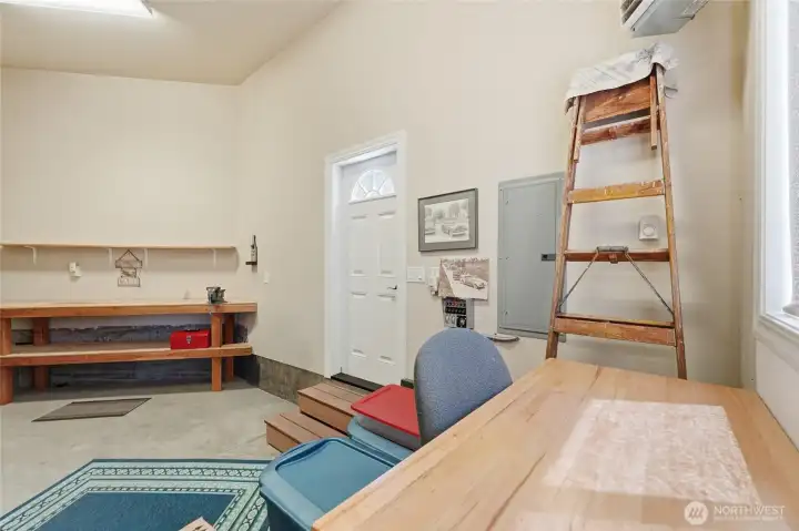 Highly functional garage design with built-ins, workbench area, and room for tools and equipment.