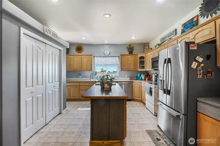 Functional kitchen with center island and pantry.