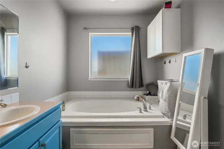 Ensuite bathroom with soaking tub and separate shower.