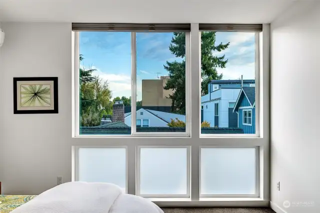 Primary suite outlooks. The windows have privacy glass and custom pull-up or down shades. With plenty of airspace between the neighboring properties and it being well sited-no one looks directly into your windows.