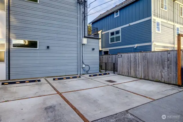 The off-street parking space is easily accessed off the alley. It is the second spot from the right. The gate leads to the pathway to the units.