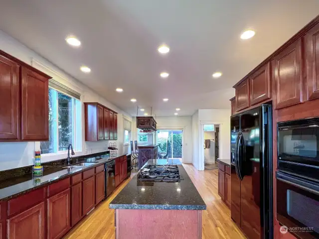 This kitchen has eating space big enough for a large table, the bar and glass holder do not convey and will be removed by seller