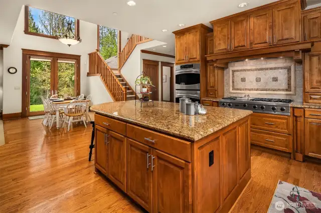 This phots shows the spacious eat in kitchen with 2nd staircase going upstairs