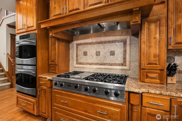 If you love to cook then you will appreciate this Viking Cooktop and & hood vent, the double wall ovens, and the deep pull out drawers and built-in spice racks spice racks.  The kitchen also features slab granite counters and beautiful tiled backsplash, and under the cabinet lighting too.
