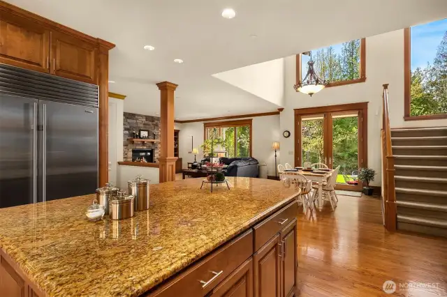 This view shows the flow from the kitchen leading out to the breakfast nook and larger family room