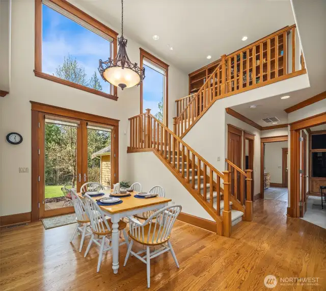 Notice the large windows on the south side of the house that brings in the natural daylight to this house.  This also shows the 2nd staircase going up into the loft / library room, and the 4 bedrooms upstairs.