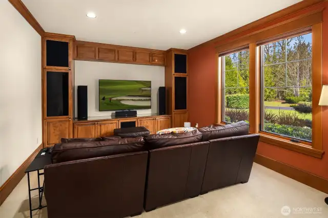 The main level Media Room with built in ceiling speakers and custom cabinetry.  This  good sized room could also make a nice recreation room.