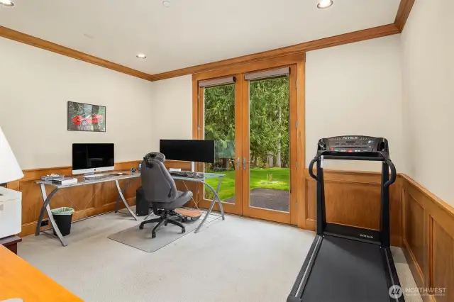 The main level den with double doors leading out the back patio area. This might be used as a 5th bedroom if needed. There is a lovely 3/4 bathroom attached to it with closet space.