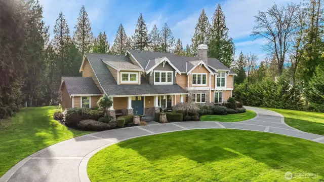 A lovely horseshoe driveway out front & beautiful lawns and garden space!