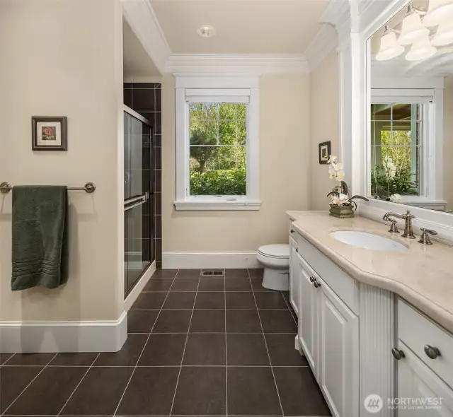 The spacious 3/4 bathroom off the den and front entry way. There is a nice size tile shower, tiled floors, and very nice sink area.
