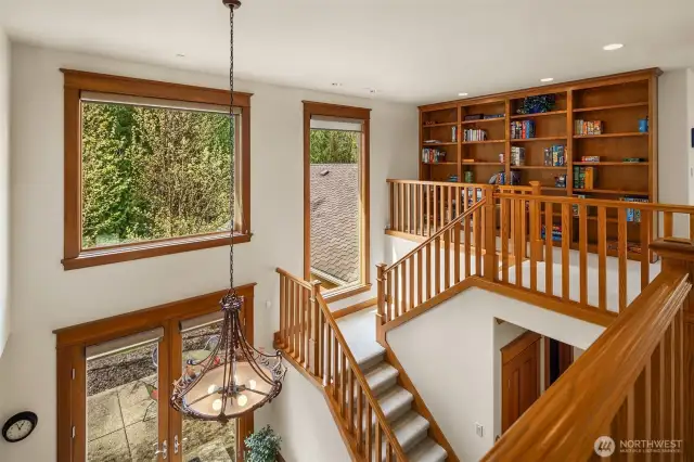 Lots of large dual pane windows with wood wrapped window trim to match the staircase and built in bookshelves upstairs.  The chandelier is over the top fo the breakfast nook area below.  This really draws in the natural lighting into the center of the home.