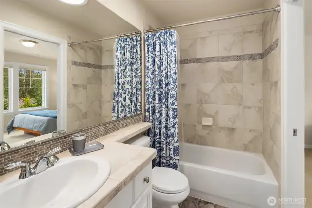 The ensuite bathroom upstairs has a nice shower over the tub, and tiled floors