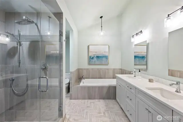 Incredible primary bathroom boasts an oversized walk in shower, jetted tub, double vanity with ample storage and large walk in closet.