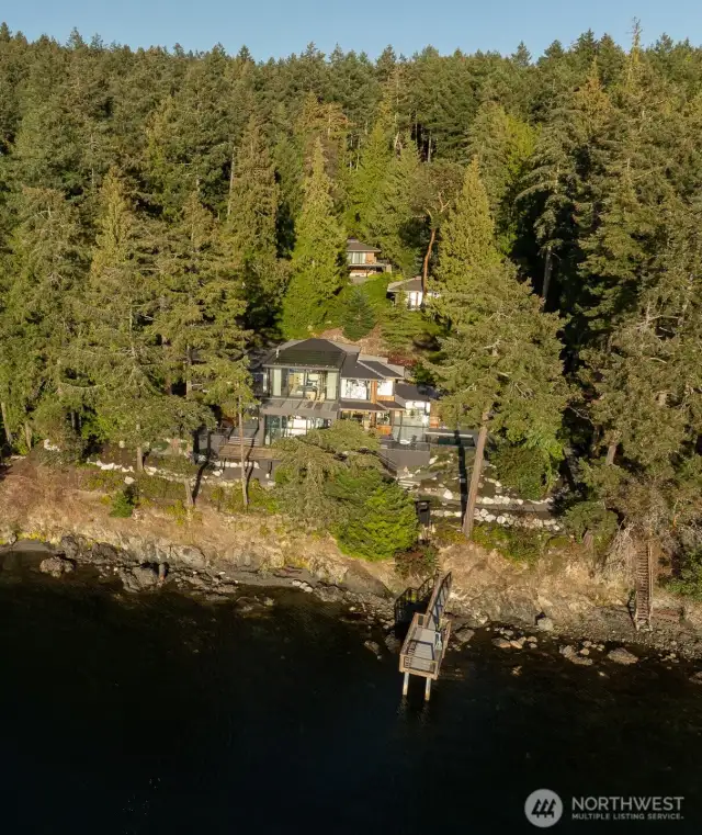 Paths meander through five acres of beautiful forests, open areas and down to the shoreline
