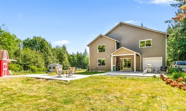 Back of home with concrete walk