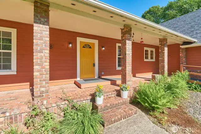 A front porch made for morning coffee and evening chats—complete with classic brick charm.