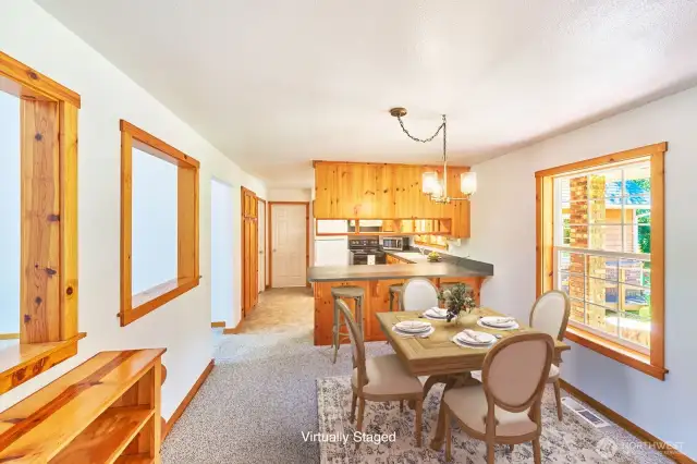 Easy flow from kitchen to table makes hosting and daily meals a breeze (virtually staged).
