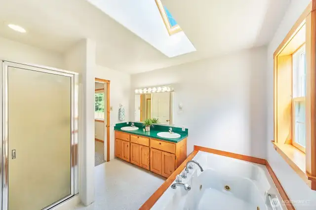 Bathroom includes dual vanities, a tiled walk-in shower, and a jetted soaking tub—perfect for everyday comfort and spa-like moments.