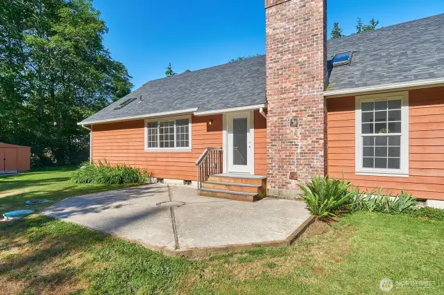 Step out from the living room onto this concrete patio with an eastern exposure, ideal for sunrise coffee or shaded afternoons.