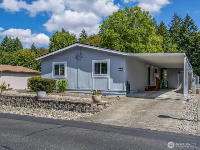 This home has a carport with an electric vehicle charger and a storage shed with electricity.