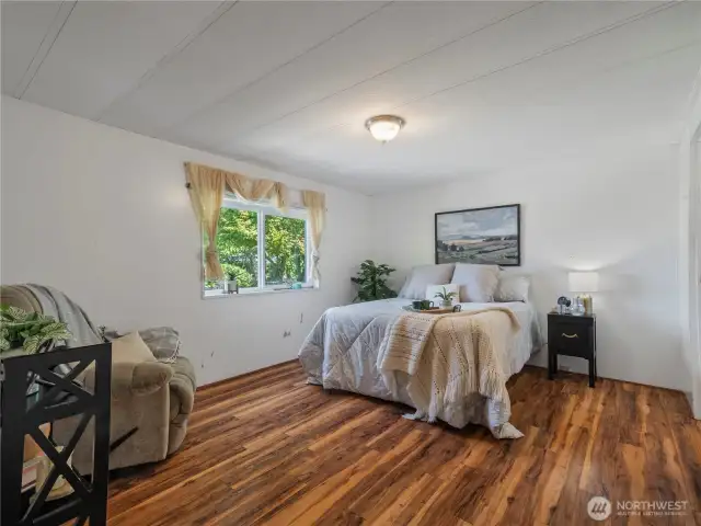 The primary bedroom is spacious and has a large closet and an ensuite.