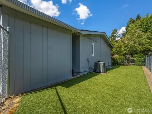 The fully fenced back yard has artificial grass for easy maintenance. the home has AC.