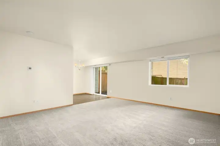 Looking into kitchen eating area and living room.  Fresh paint/carpet through out.