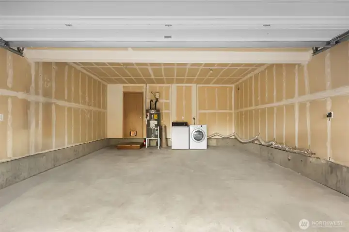 2 car garage on EACH SIDE - 4 car total.  4 cars in driveway spaces too. Auto opener included.