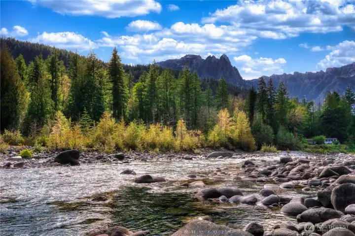 From the river's edge, your view stretches from flowing water to the peaks of Mount Index.