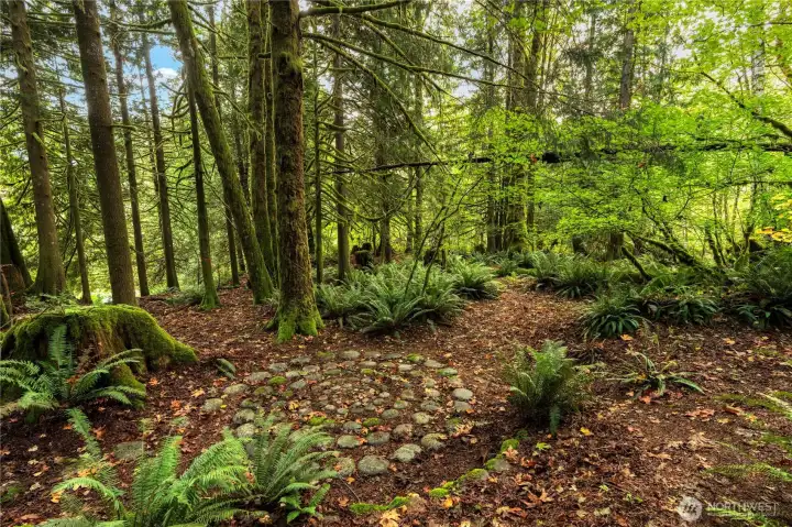 The Swirl, created with rocks brought up from the river, was created by landowner, who lives next door to the property for sale. The boundary between the two properties runs through the center of the Swirl and it can be shared by both.