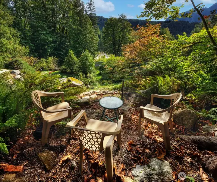 A thoughtfully designed sitting area captures tranquil views of the river and iconic Mount Index.