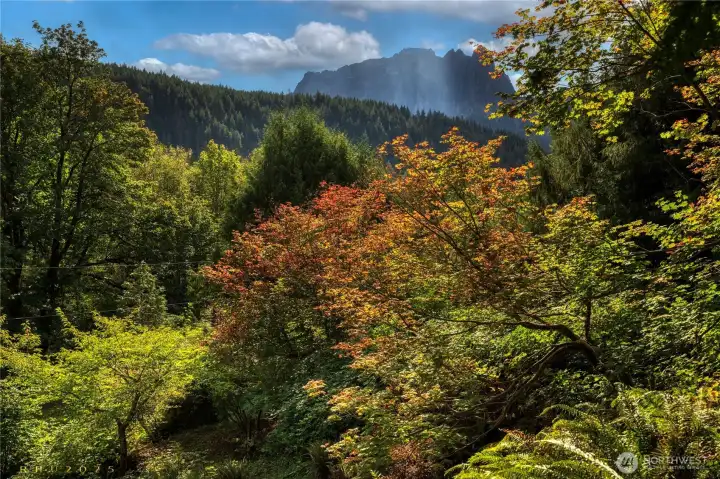From the sitting area, autumn's colors unfold with Mount Index rising beyond.