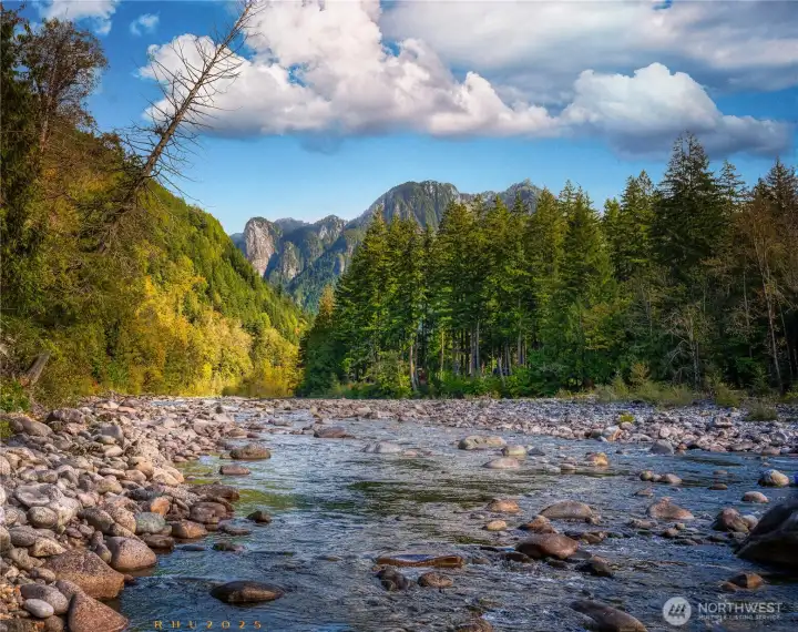 The north fork of the Skykomish River on a peaceful September morning. The park-like open meadow is about 20 feet to the left of the rocks and is out of the photo.