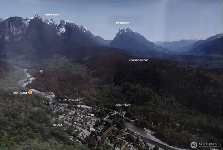 The orange circle shows location of the property for sale. Dominating the view to the east is a range of peaks, some within the recently designated Wild Sky Wilderness. The Skykomish River winds its way through the valley and past the town. The town’s famed rock climbing cliffs are out of sight above Index.