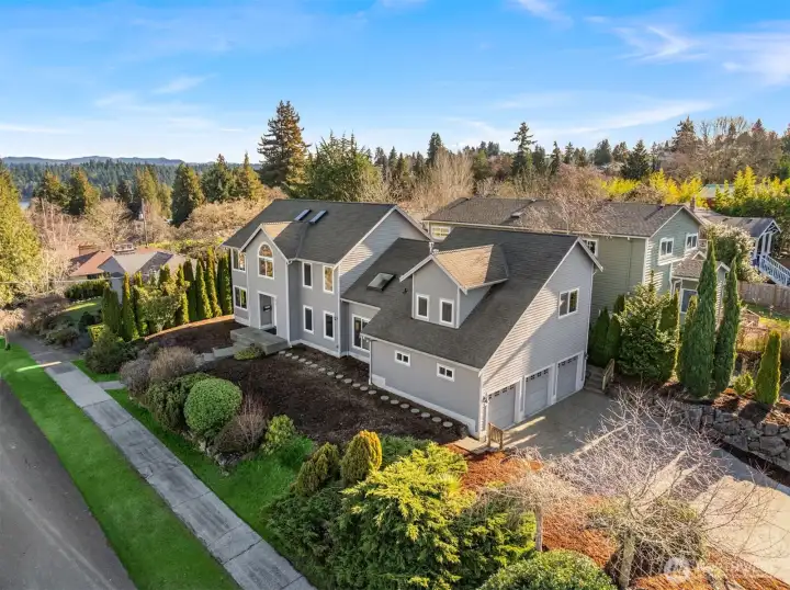 Corner lot with south facing back yard, professional landscape, and 5 car driveway.